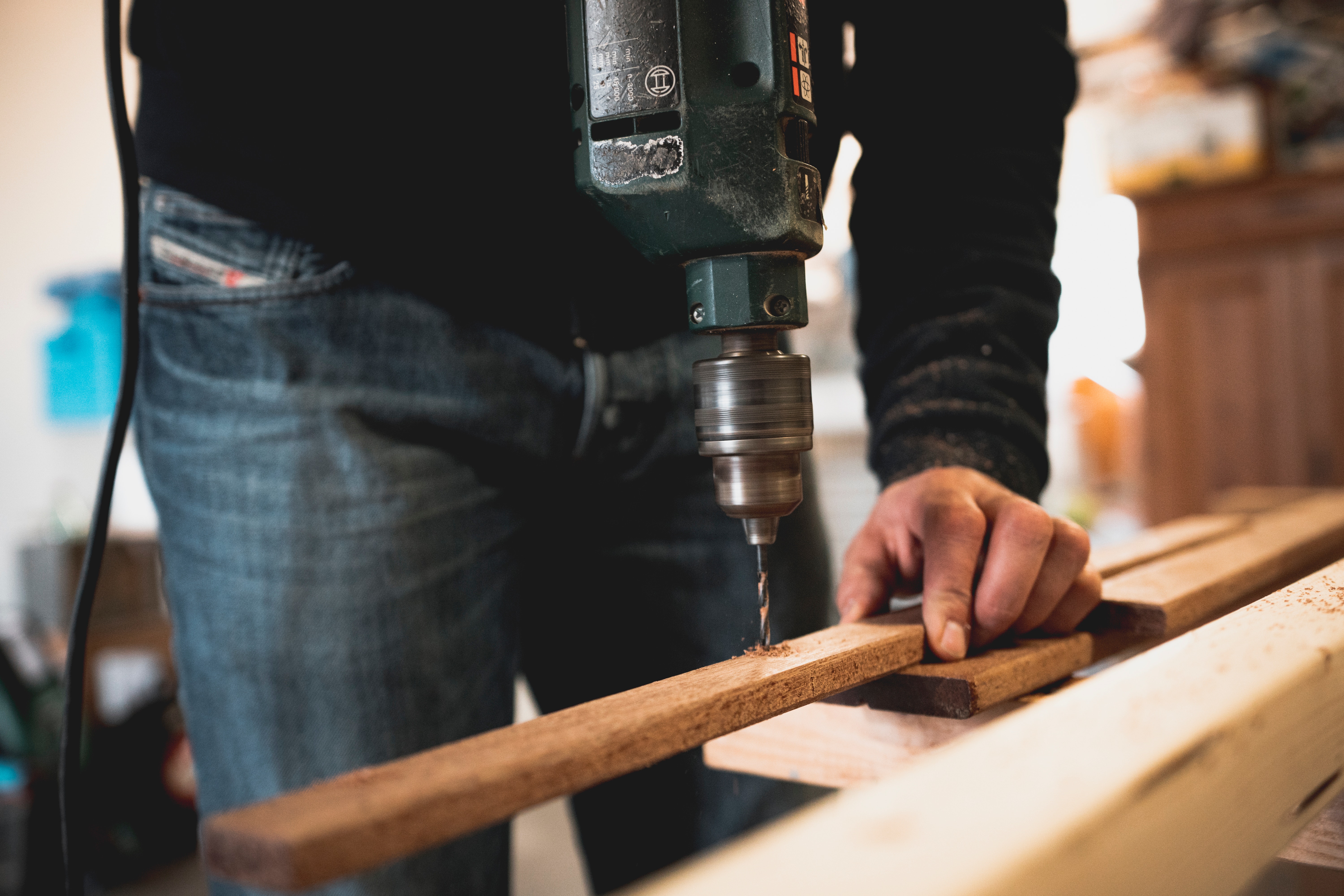 Man using his worktables for workshop to fix something at home.