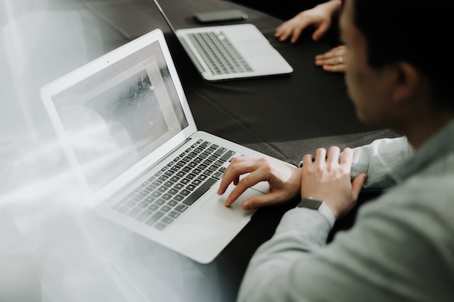 office man looking at a laptop on a desk